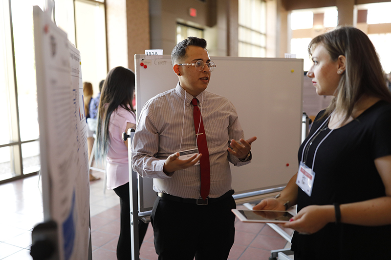 Oscar Najera, a junior psychology major, presents his research at the 2019 Campus Office of Undergraduate Research Initiatives (COURI) Summer Symposium on August 3, 2019. His project seeks to determine whether speakers of two languages can use a memorization technique known as Paired Associative Learning more successfully than monolingual people. Photo by Ivan Pierre Aguirre / UTEP Communications 