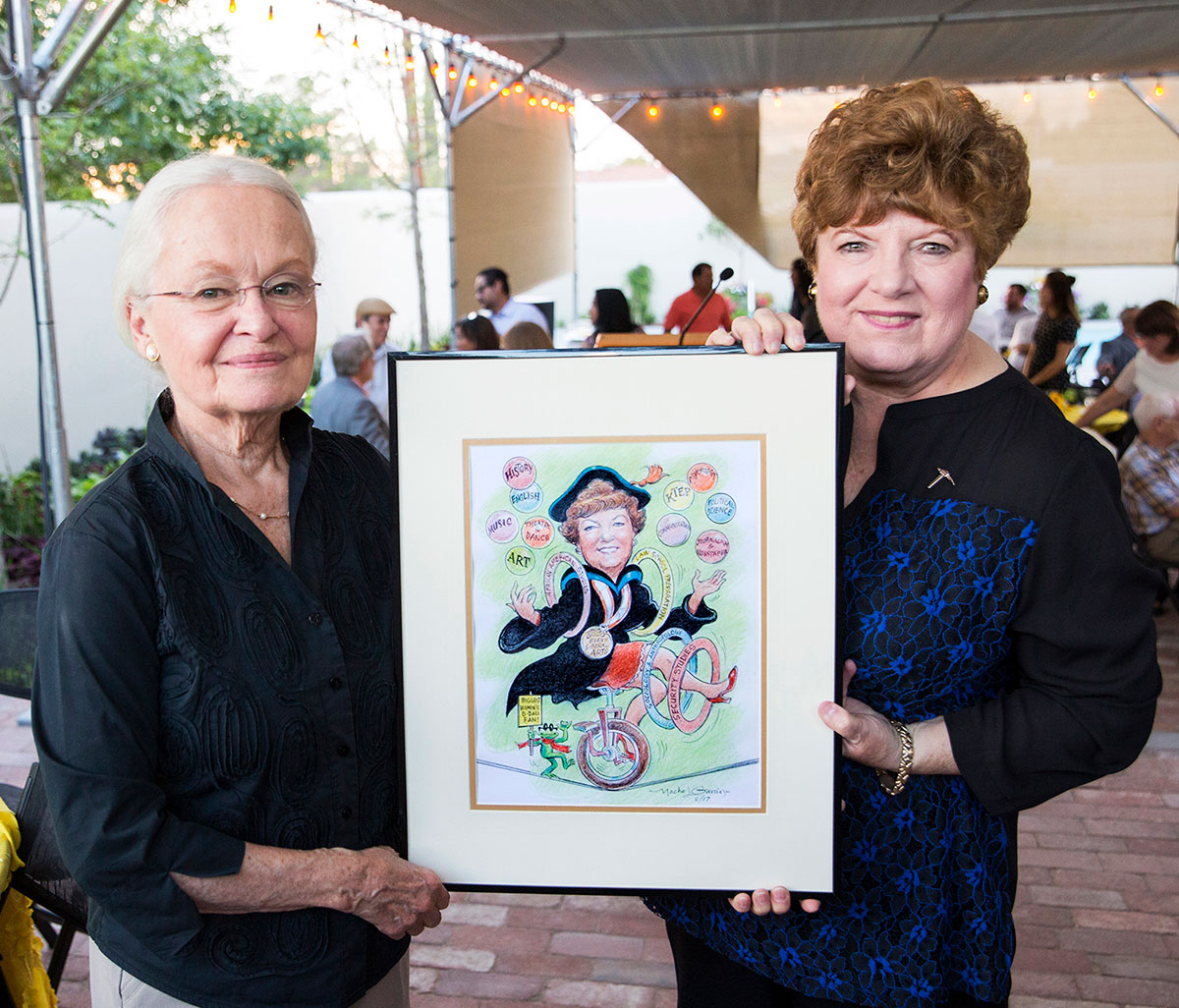 UTEP College of Liberal Arts Dean Patricia Witherspoon, Ph.D., (right) retired in August after 17 years at UTEP. Witherspoon and UTEP President Diana Natalicio (left) hold a caricature of Witherspoon by Nacho L. Garcia. Photo by UTEP News Staff 