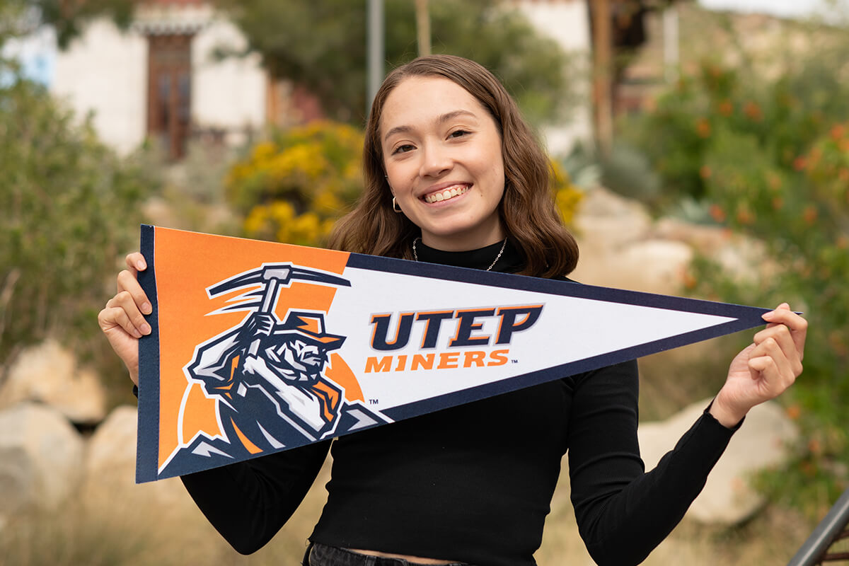 UTEP Student holding banner