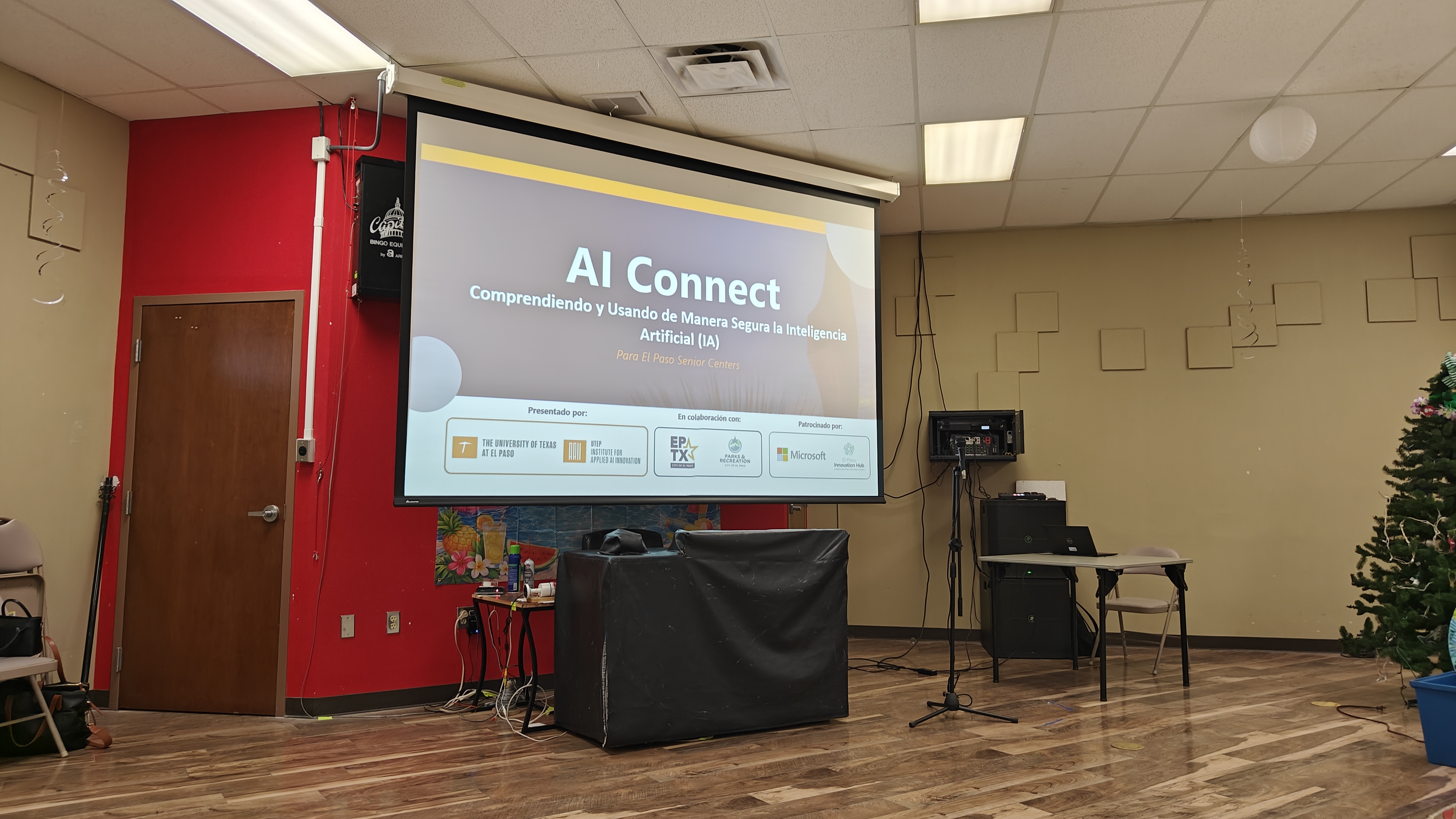 The AI Connect title slide, in Spanish, projected at a City of El Paso senior center before a session.