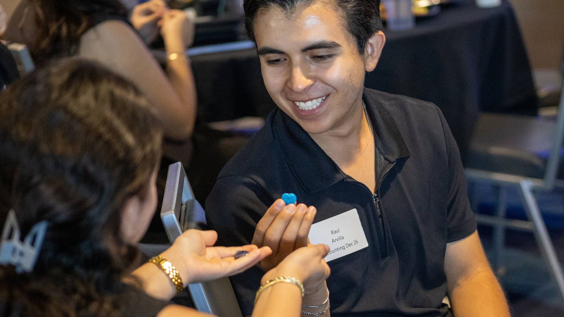 A Hunt College student exchanges a heart-shaped rock during Kathrin Berg's keynote exercise