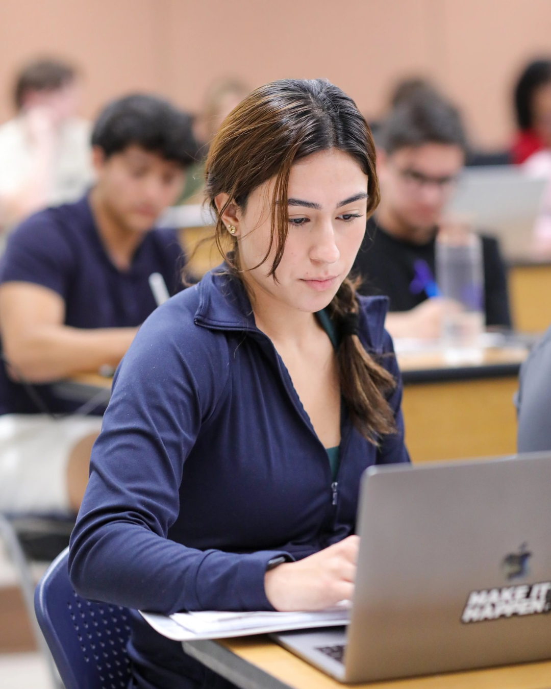 Student working on a laptop in an AIS classroom