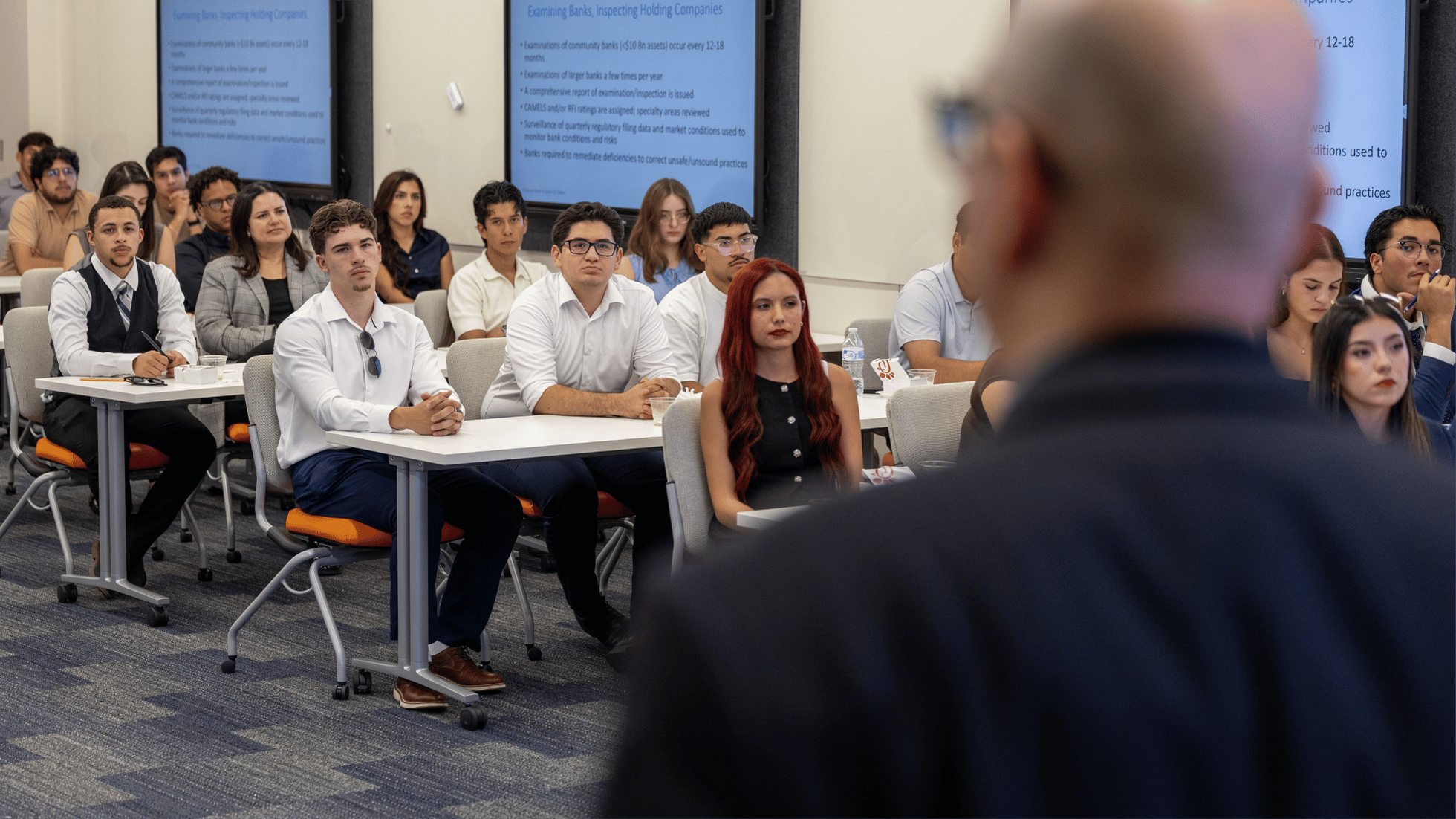 Hunt College students listen to a Federal Reserve Bank of Dallas representative discuss bank supervision.
