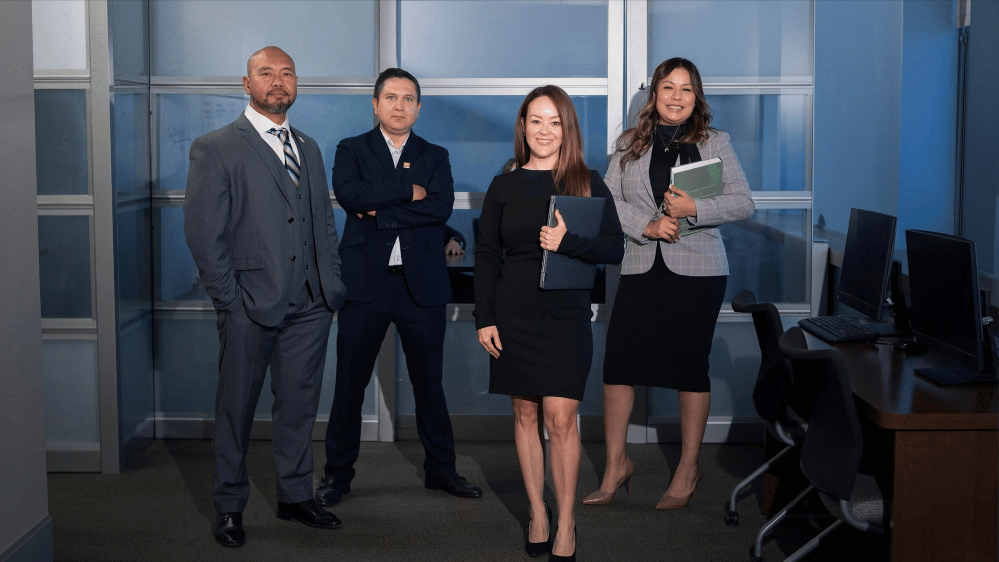 UTEP Executive MBA students stand together in professional attire.