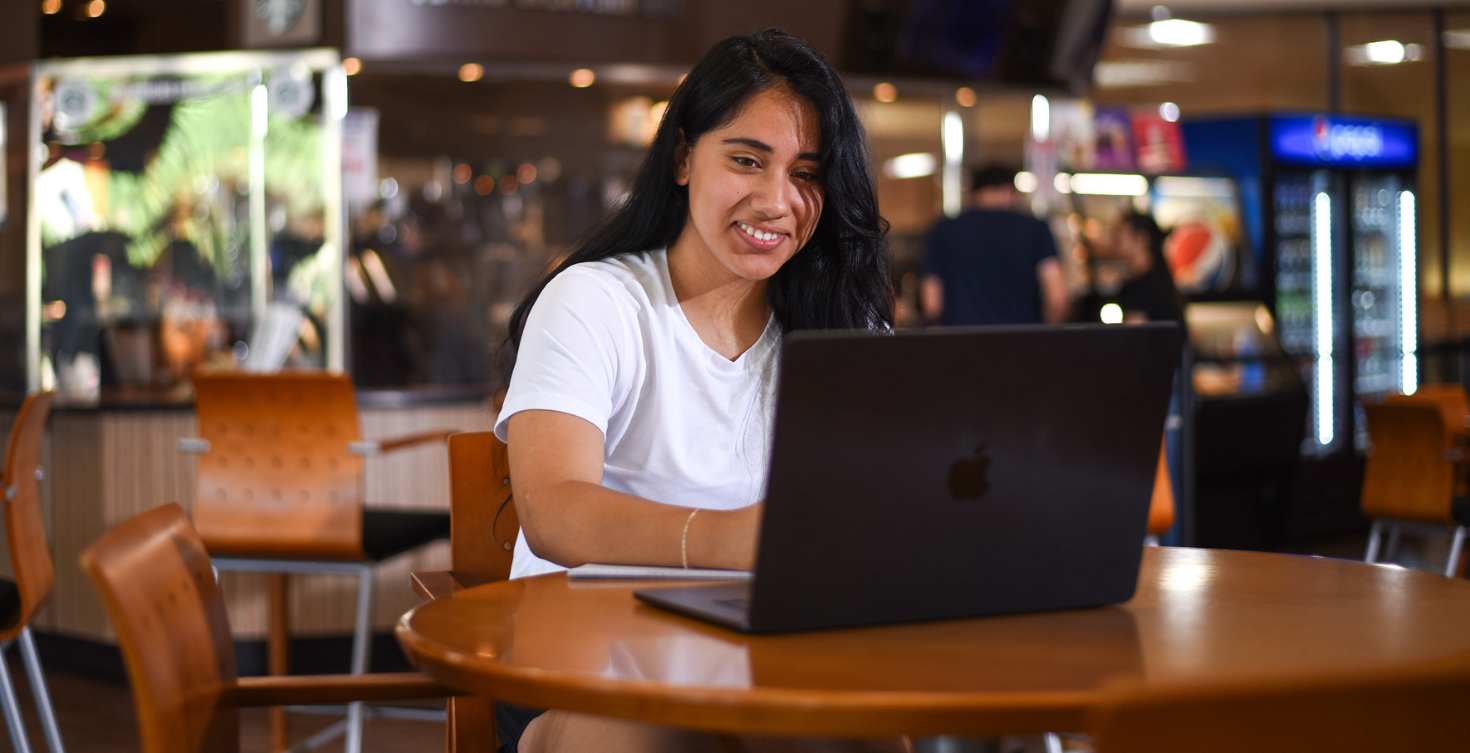 Online MBA student working on laptop