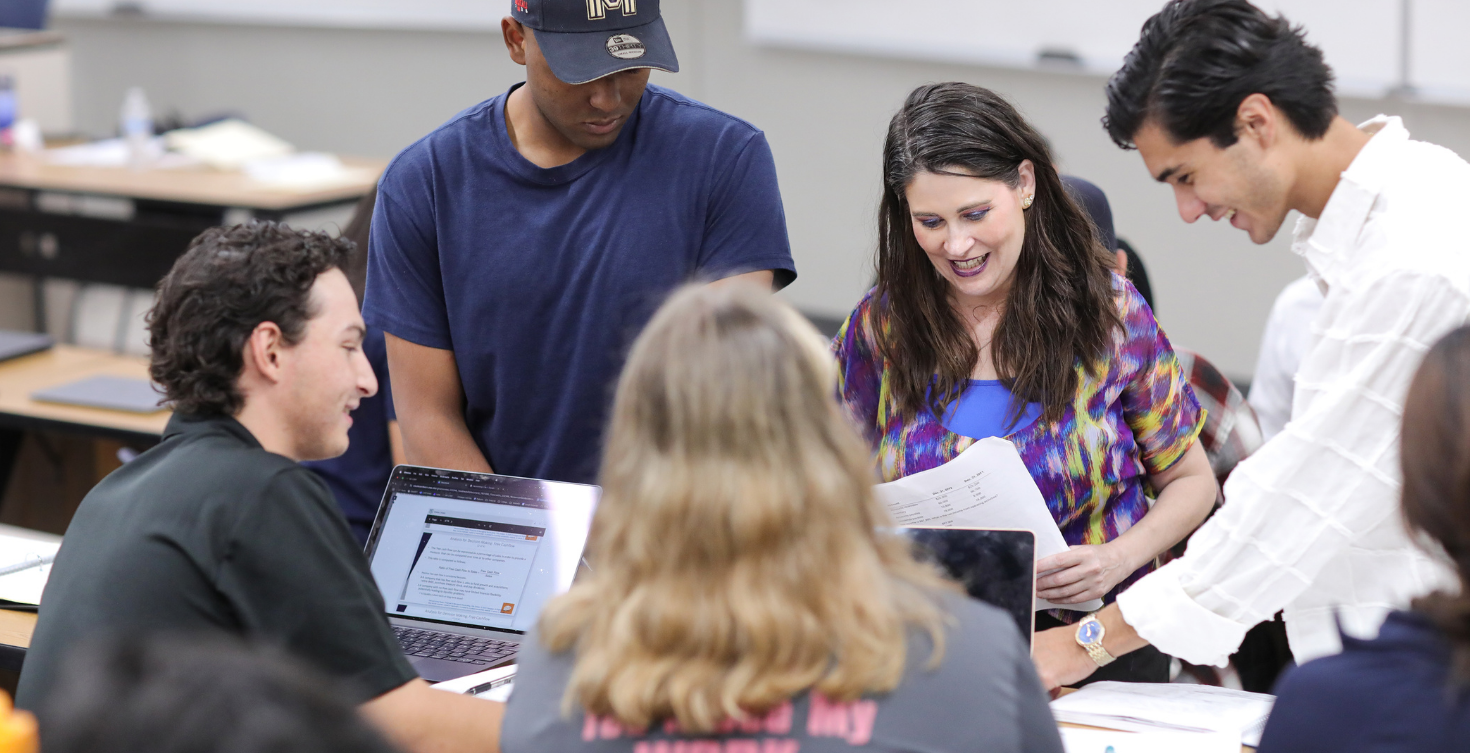 Hunt College students and an instructor working together in class.
