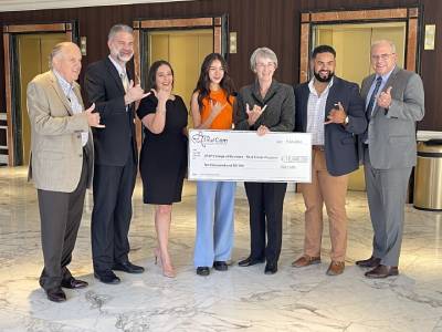 UTEP President Dr. Wilson & COBA Dean Dr. Payne accepting a $10,000 check donated on behalf of WestCom 2022 with graduates of the CRE minor. 