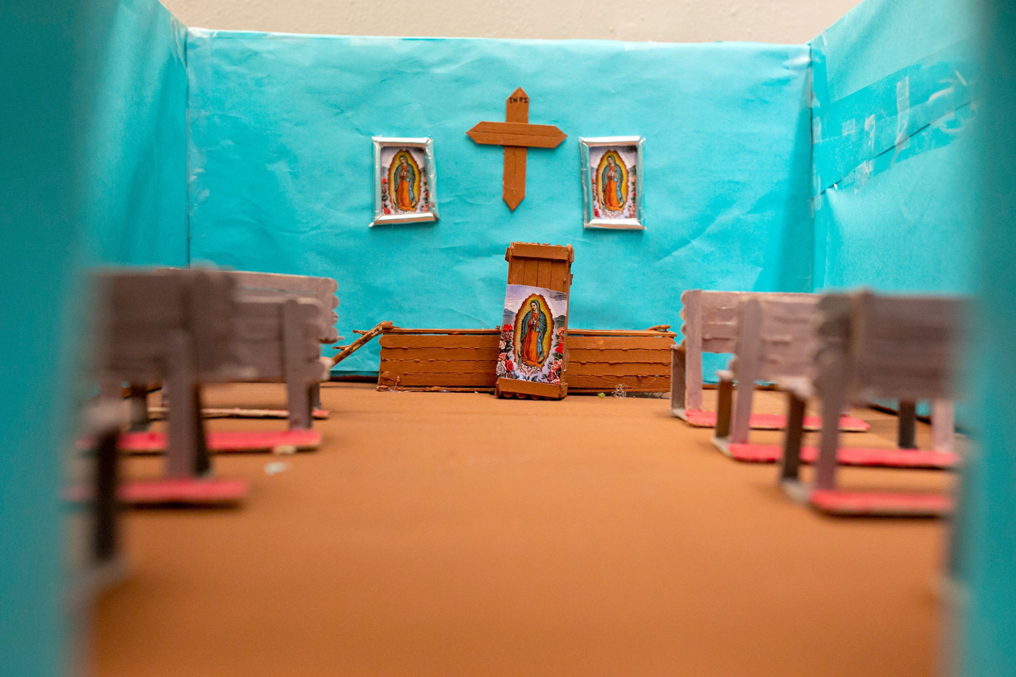 A cut-cardboard cathedral made by a teen at Tornillo is wrapped in vibrant aqua tissue paper, with pews for the faithful made from Popsicle sticks. Photo by Ivan Pierre Aguirre