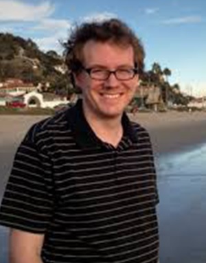 Portrait of Dr. Thomas Moschak striped shirt on the beach