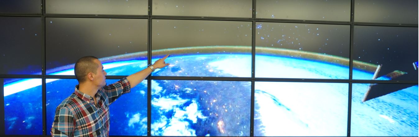 Image of a Person explaining his research.