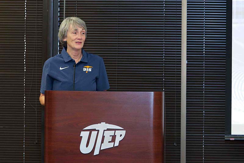 Heather Wilson speaking at a podium with a UTEP logo on the front.
