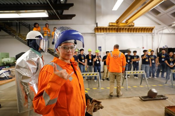 A Mining Camp participant wearing protective equipment during a safety demonstration.