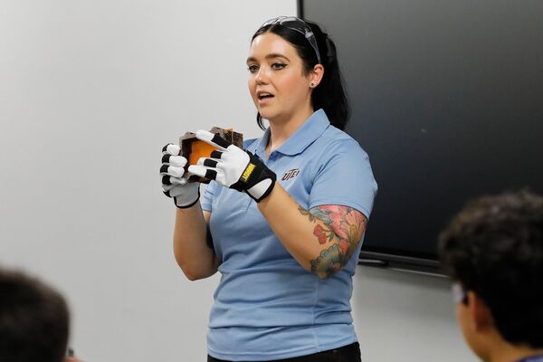 An instructor speaking to Mining Camp participants during a classroom session.