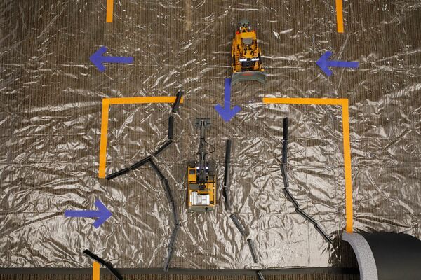 A mine operation model with arrows showing movement paths and equipment placement.