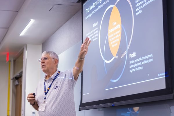A presenter speaking to Mining Camp students during an industry presentation.