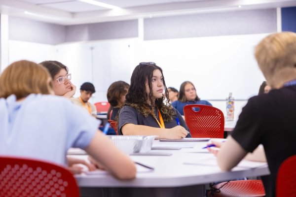 Mining Camp students seated at classroom tables during a group discussion.