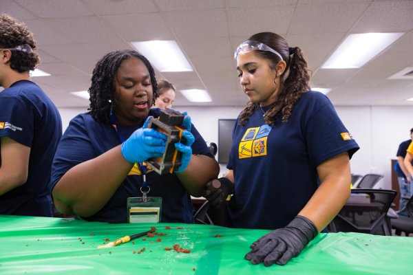 Mining Camp students working together on a hands-on foundry activity.