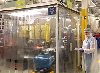 Senior industrial engineering student Eloy Deras walks CareFusion's manufacturing production line. Deras is working to improve the line's efficiency with his technical engineering skills. Photo courtesy of Eloy Deras.