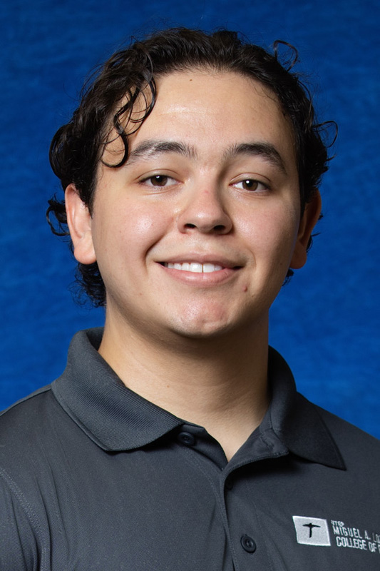 Professional headshot of Azahel Jurado with short curly dark hair wearing a gray UTEP College of Engineering polo shirt, facing forward against a blue studio background.
