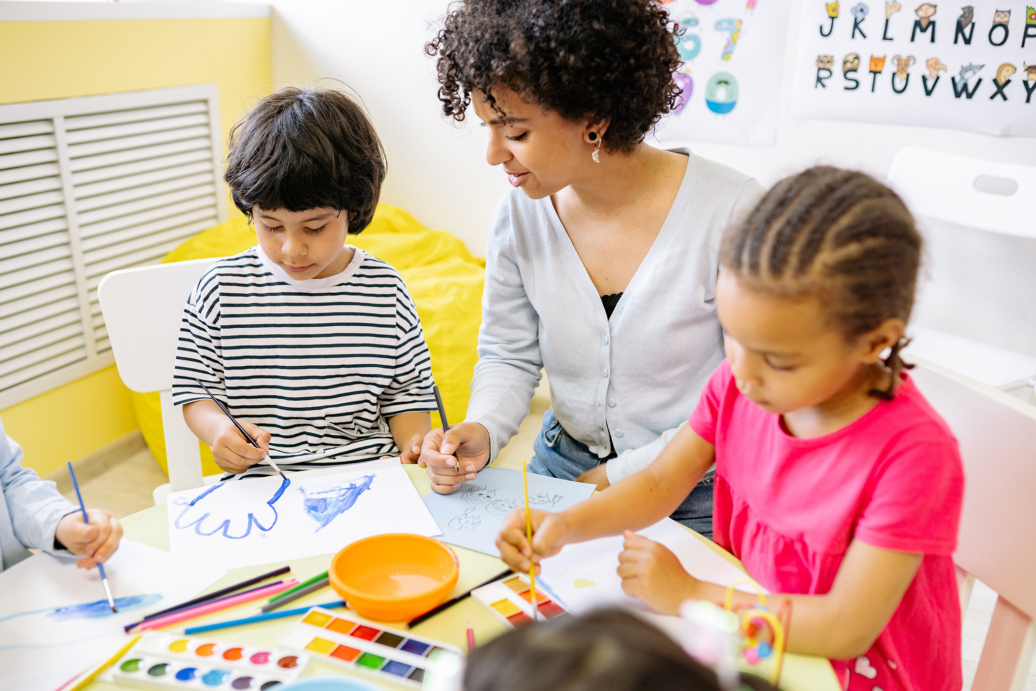 Teacher with little kids in classroom