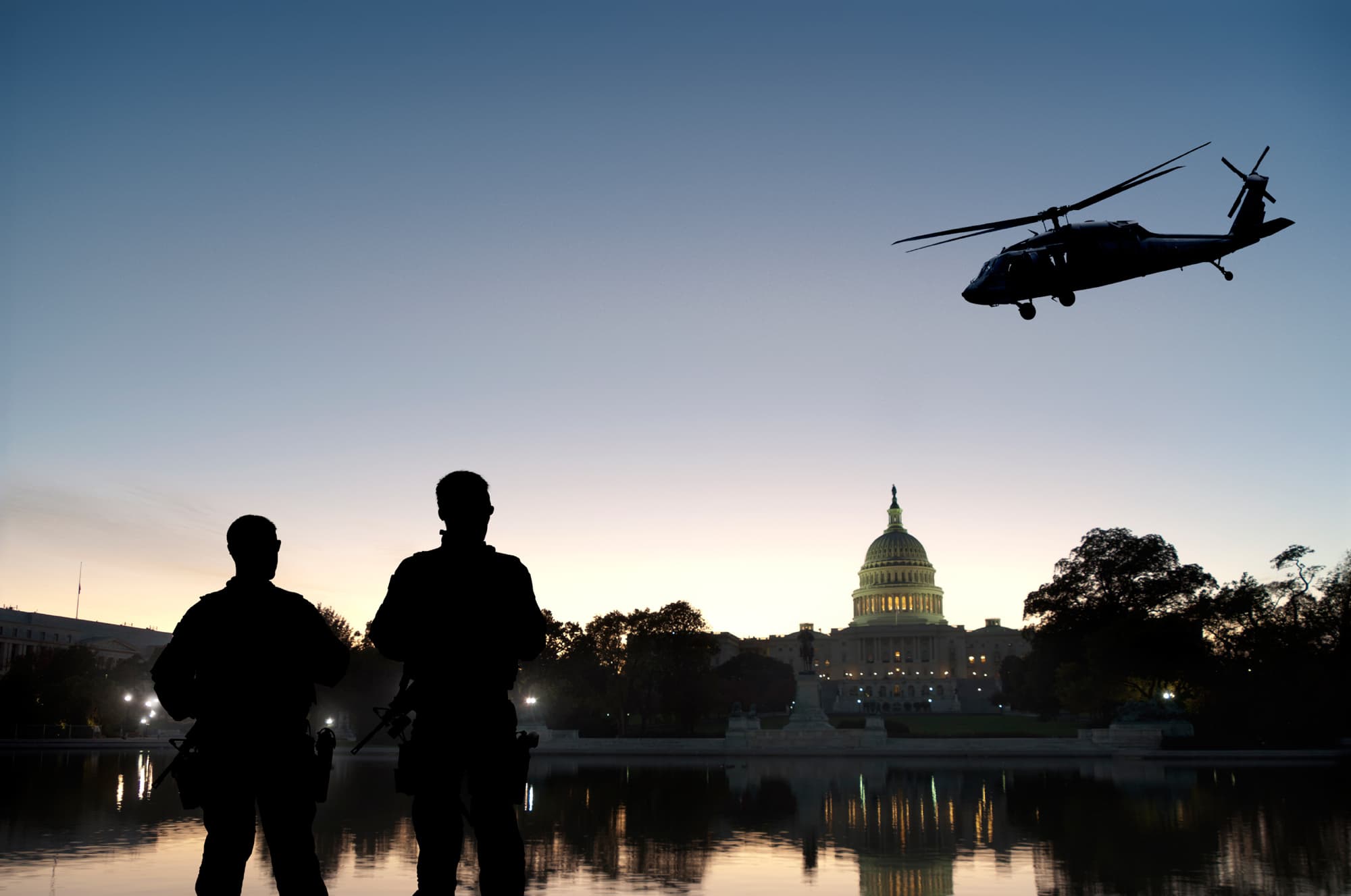 Armed military near helicopter