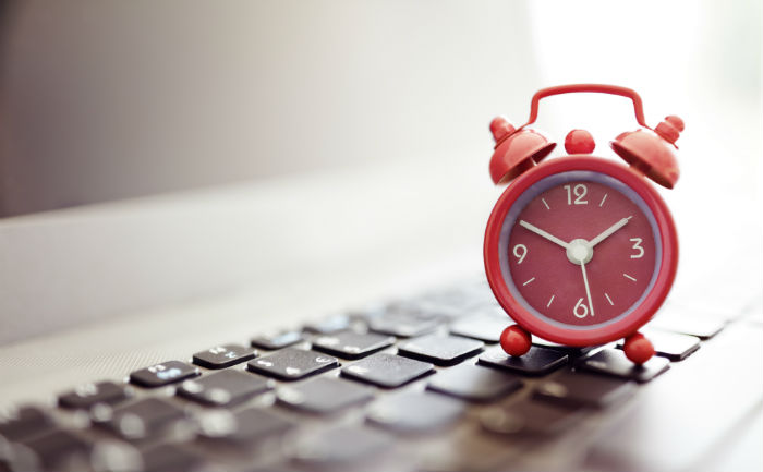 Clock on a keyboard indicating the time is always right to earn your online degree