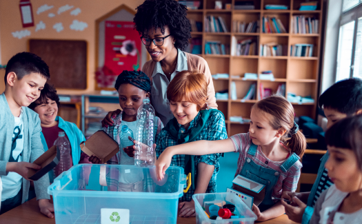  Image of a woman teaching children about recycling