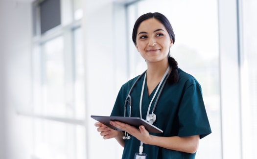 Woman in nurse uniform holding a tablet