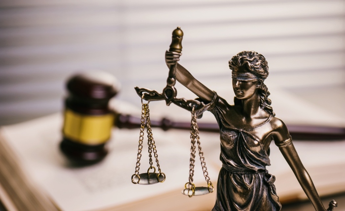 Close-up of Lady Justice against a gavel on a law book | UTEP Connect