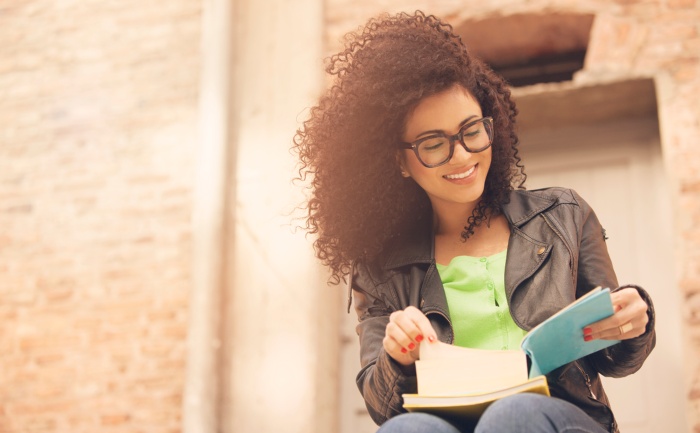 Young Latina studying during summer