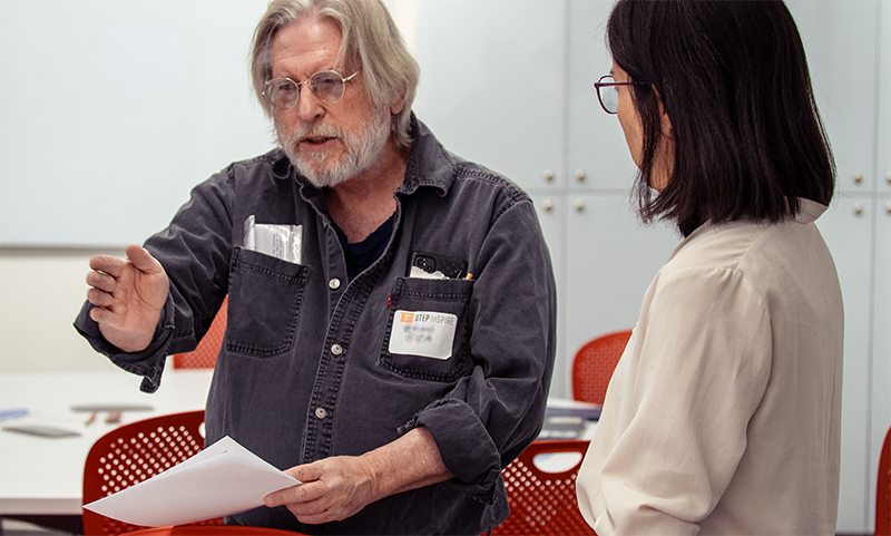 Two utep faculty members deep in discussion at a conference workshop