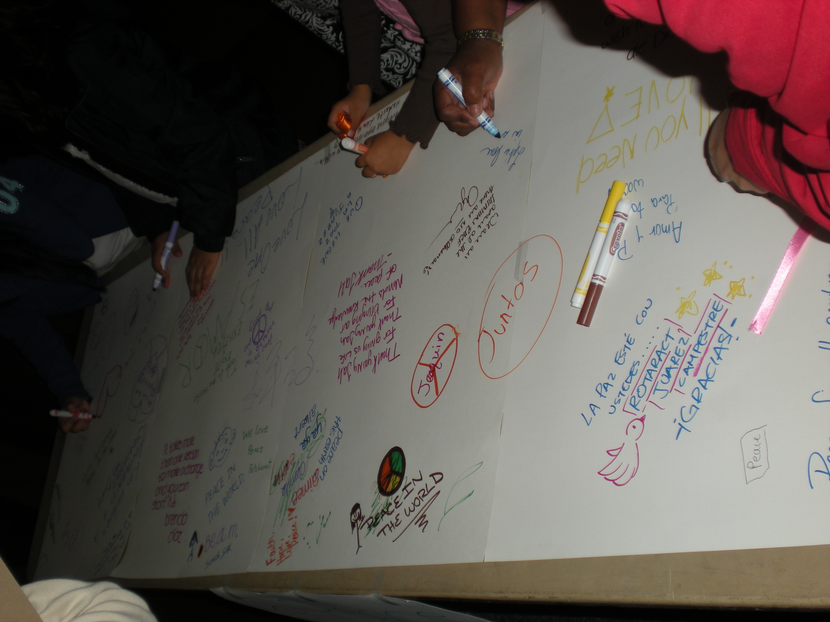 Students signing the Peace Wall
