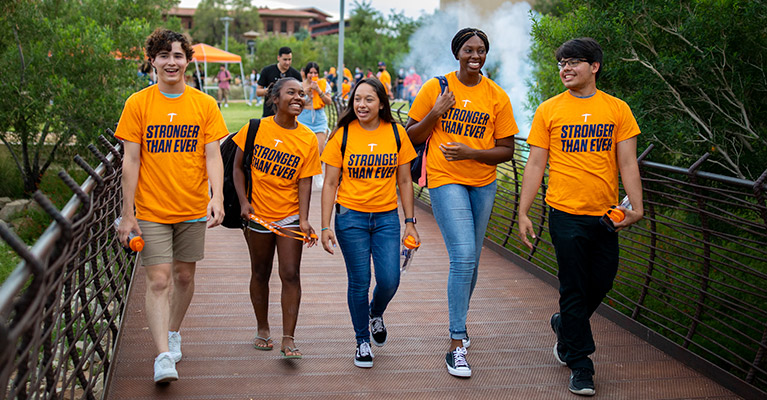 Students strolling in campus smiling