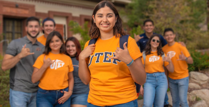 UTEP Students holding making a picks-up sign