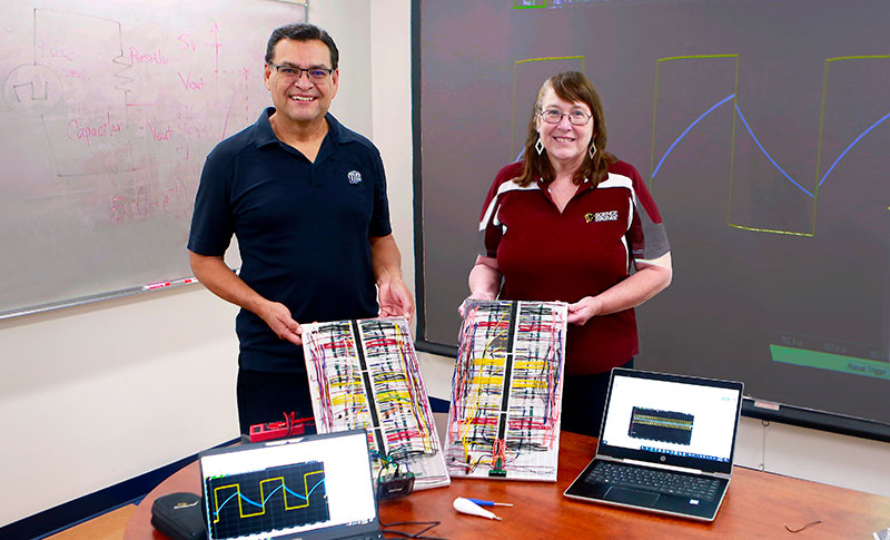 UTEP's David Zubia, Ph.D., professor of electrical and computer engineering, and Lisa Roth, a science teacher at Gadsden High School, were part of a summer partnership organized by Project ACE, a program created to increase the number of underrepresented students who pursue undergraduate degrees in engineering as well as biomedical and behavioral sciences. Roth built and tested a “Personal Lab” circuit board that Zubia created and patented. Photo: Laura Trejo / UTEP Communications 