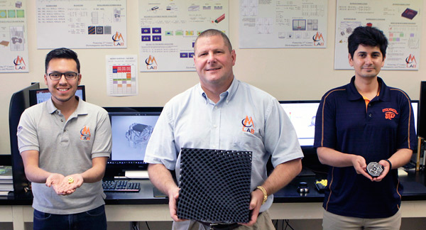 Raymond C. Rumpf, Ph.D., center, stands with two of his graduate research assistants, Gilbert Carranza, left, and Cesar Valle. The trio work in Rumpf's EM Lab in The University of Texas at El Paso's College of Engineering. This year, the lab developed the world's first 3-D/volumetric circuit. Photo: Laura Trejo / UTEP Communications 