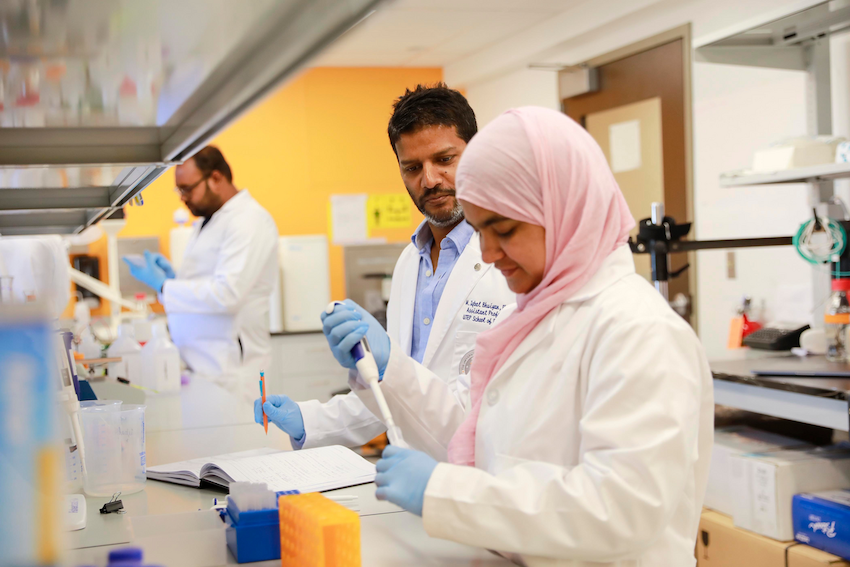 Mohammad Iqbal Bhuiyan, Ph.D., (center) supervises Khadija Habib, Ph.D. as she conducts lab research. Credit: The University of Texas at El Paso 