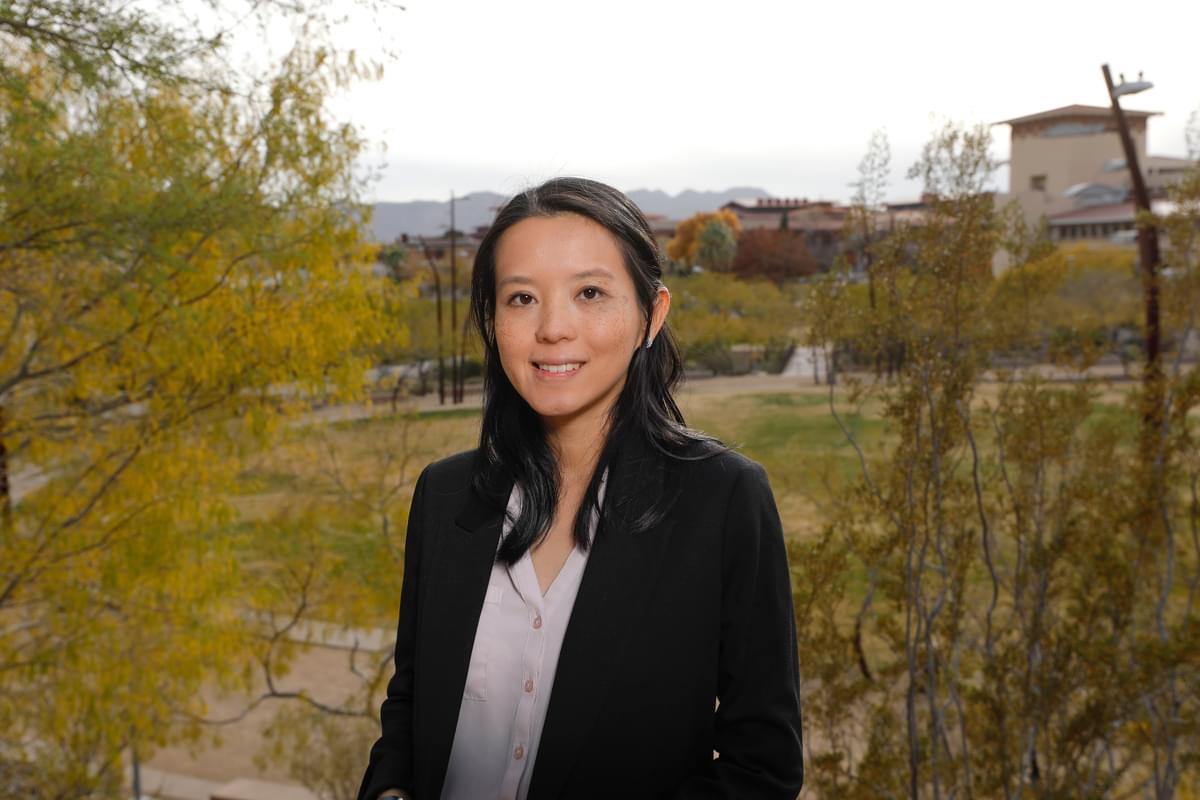 Beatrice Lee, Ph.D., A woman standing to pose for a photo. In the background is a grassy area known as UTEP's Centennial Plaza  