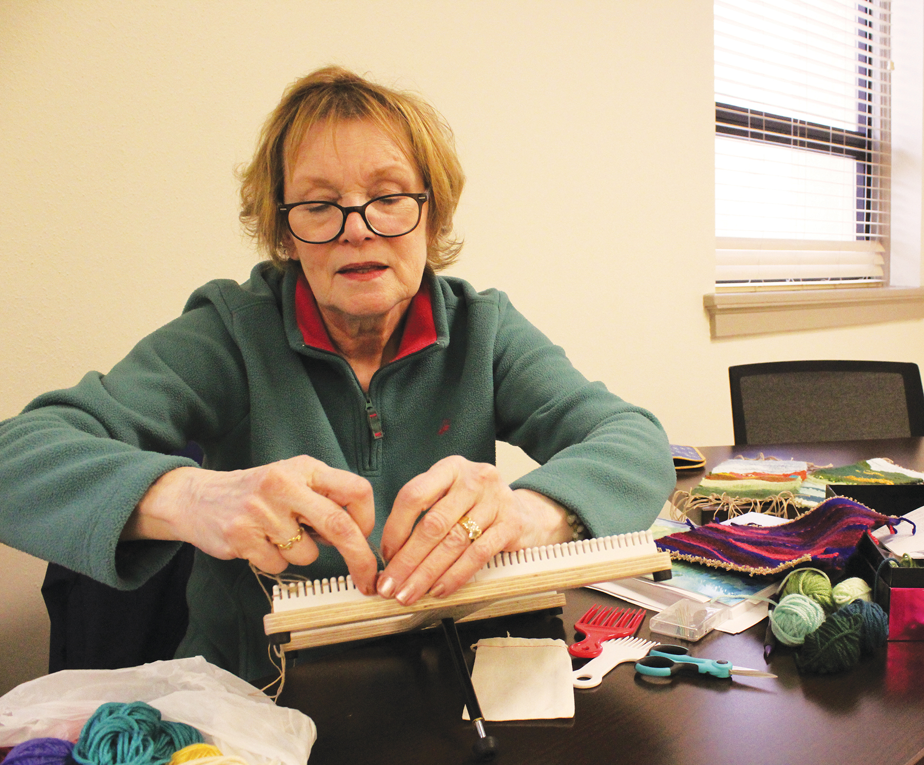 Adult woman working on craft project. 