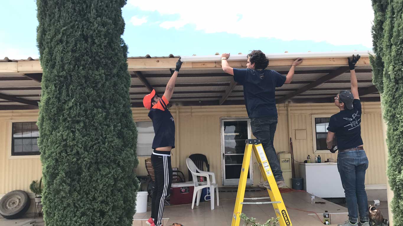 Student volunteers from The University of Texas at El Paso help install a rainwater harvesting system at a home in the Las Pampas colonia near Presidio, Texas, in this June 2017 photo. 