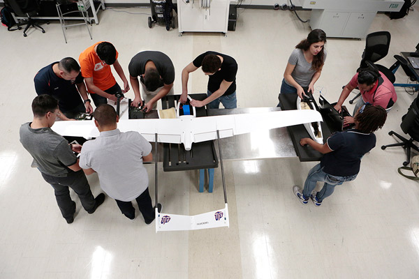 Engineering and computer science students work on a drone inside a laboratory in the Education Building on The University of Texas at El Paso campus. Unmanned aerial systems (UAS) experts from UTEP's NASA MIRO Center for Space Exploration and Technology Research (cSETR) have leveraged the efforts of 30 computer science and electrical and mechanical engineering students to develop very long range unmanned aircraft systems technology. Photo: J.R. Hernandez / UTEP Communications 