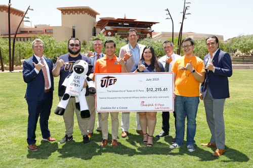 The University of Texas at El Paso’s Student Emergency Fund was bolstered by a $12,215 gift from Chick-fil-A presented Friday, July 16, 2021, during a ceremony at Centennial Plaza. The money was collected during the restaurant’s Cookies for a Cause campaign in April 2021. Taking part in the ceremony were, from left, Jake Logan, vice president for institutional advancement at UTEP;  Carlos Chavez, UTEP Student Government Association (SGA) senate majority leader/senator-at-large; Anthony Martinez, Chick-fil-A operator; Carlos Mora, SGA senator-at-large; Sergio Denver Chavez, Chick-fil-A operator; Kimberly Sanchez, SGA senator-at-large; Marc Zayas, Chick-fil-A operator; Armand Avila, SGA vice president for external affairs; and Edgar Ortega, Chick-fil-A operator. Photo: Laura Trejo / UTEP Communications 