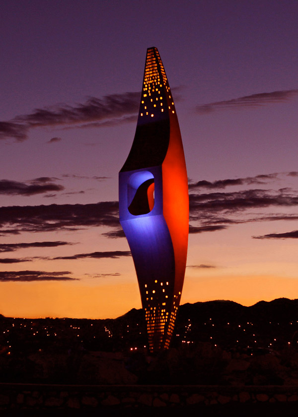 The “Mining Minds” pickaxe sculpture at UTEP’s Sun Bowl-University roundabout will be illuminated in blue and orange beginning Saturday, Sept. 28, through Saturday, Oct. 5, in honor of two special occasions at The University of Texas at El Paso. Photo: Laura Trejo / UTEP Communications 