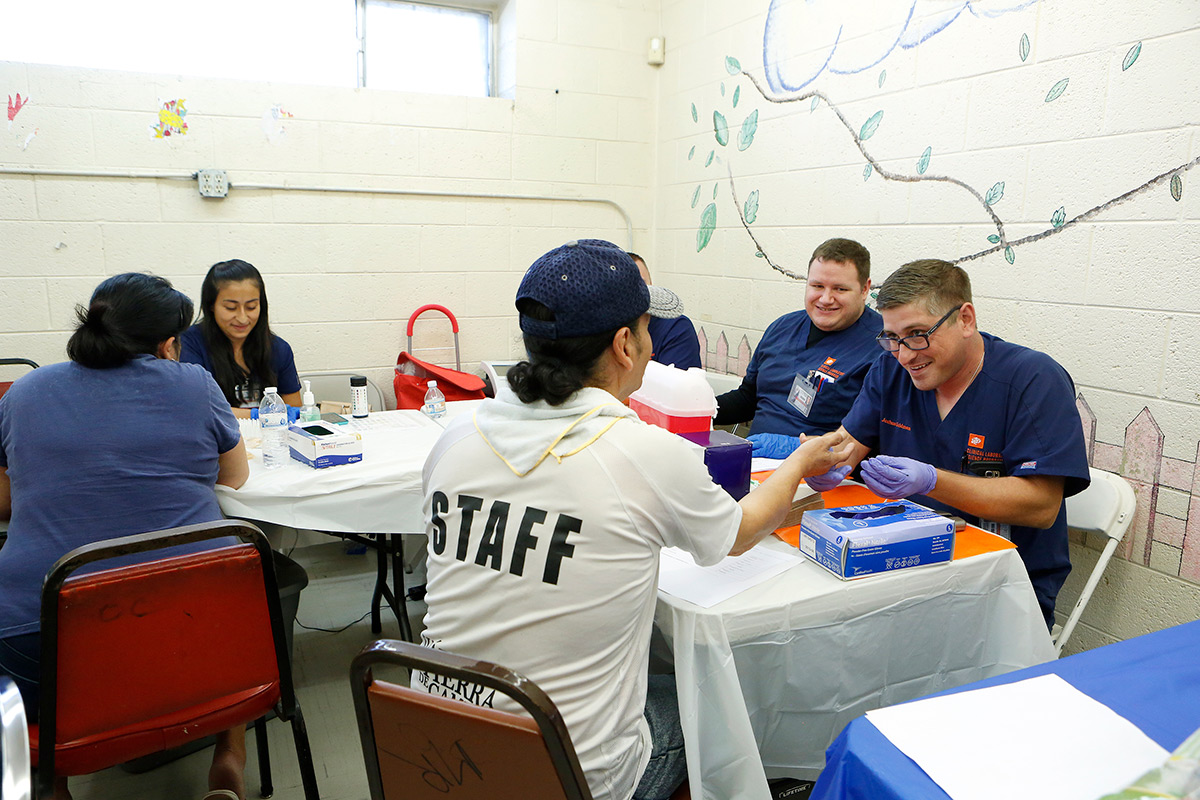 Joshua Goldman, a senior clinical laboratory science major, draws a small blood sample from a patient who attended the H.O.P.E. (Health, Opportunity, Prevention, Education) clinic Oct. 10, 2017, at the Opportunity Center for the Homeless. Photo: J.R. Hernandez/University Communications   