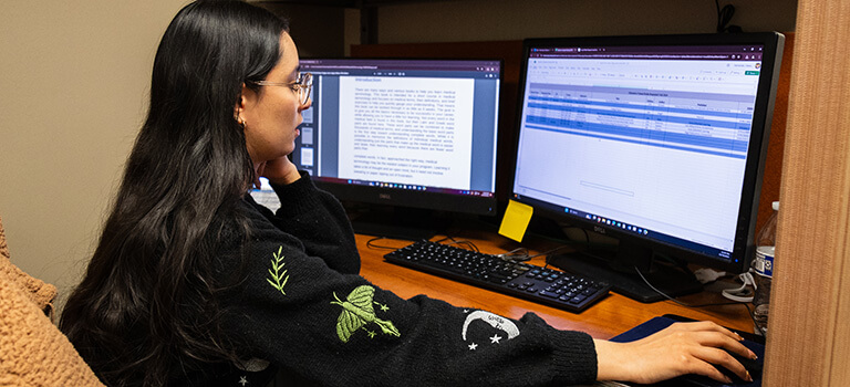 UTEP student note taking on computer