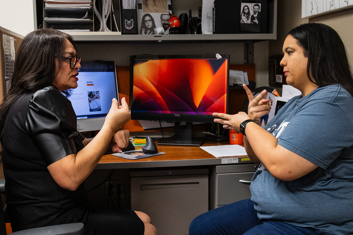 sign language interpreter teaching a student