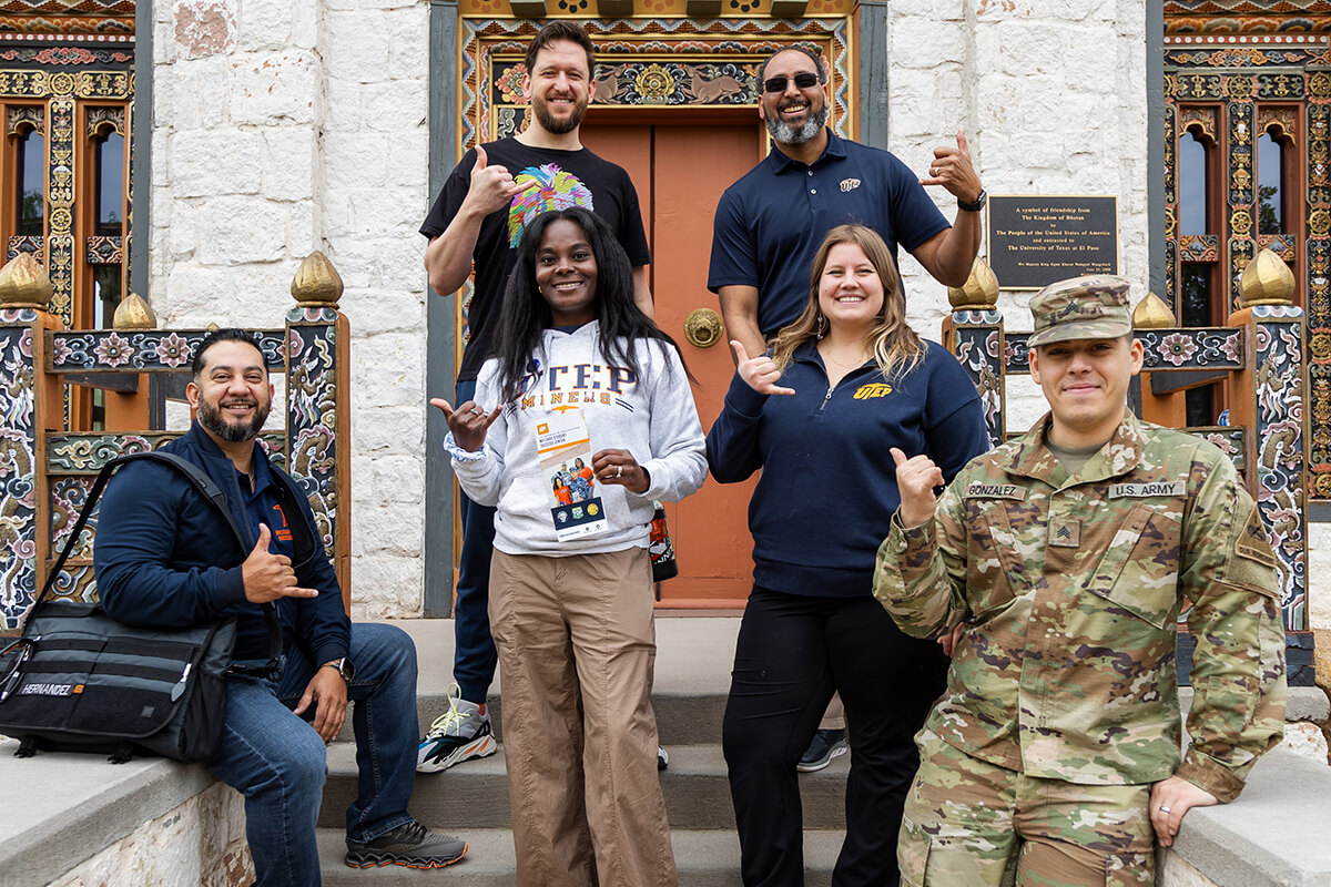 UTEP student showing there miner pride with pick up hand sign